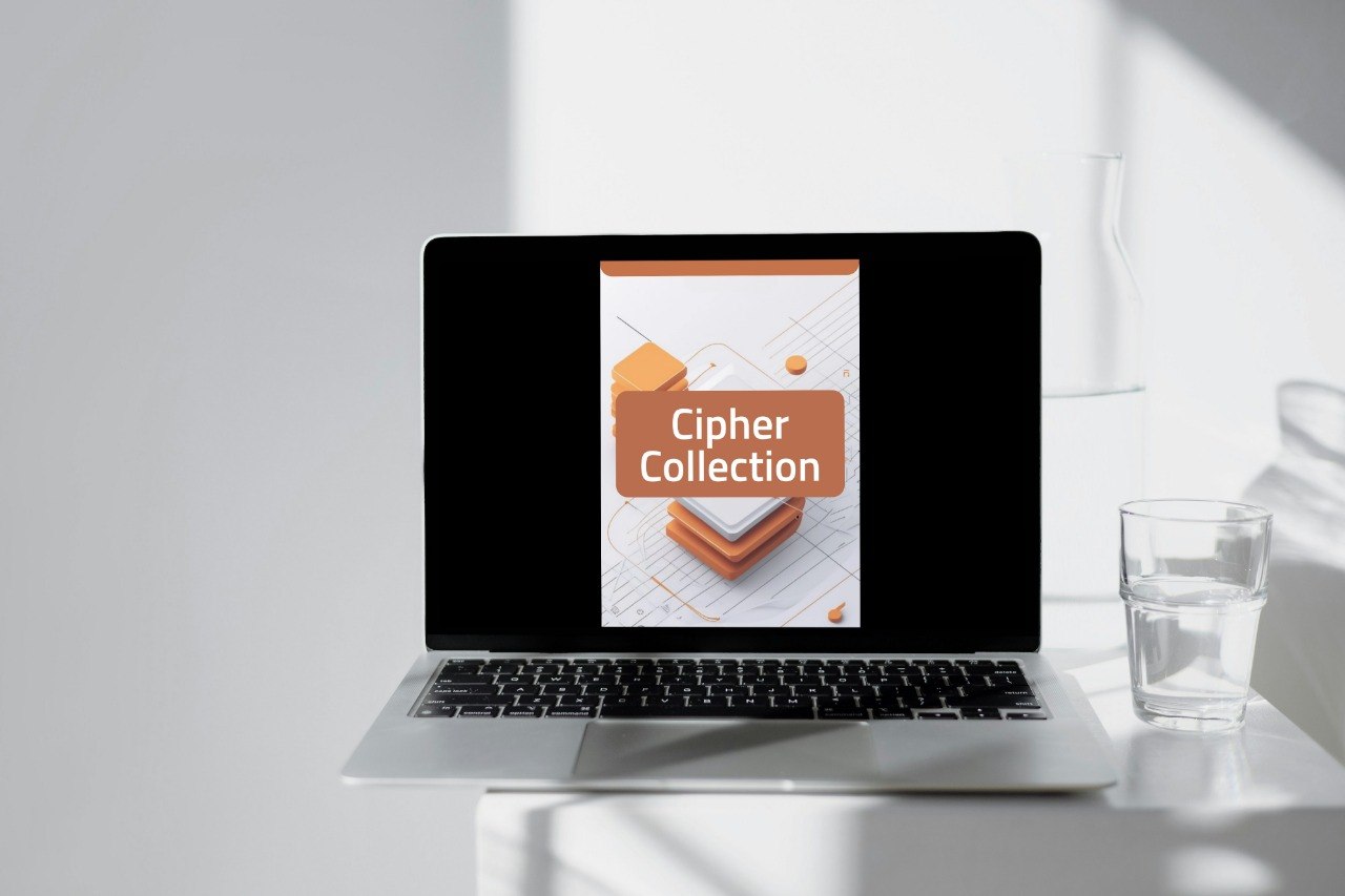 A silver laptop sits on a white table in a bright, modern room, displaying a digital cover for 'Cipher Collection' on its screen. A glass of water and a white vase are visible in the background with soft shadows.